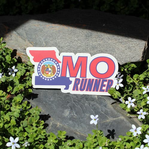 Missouri Running Sticker laying on rocks with white flowers for website