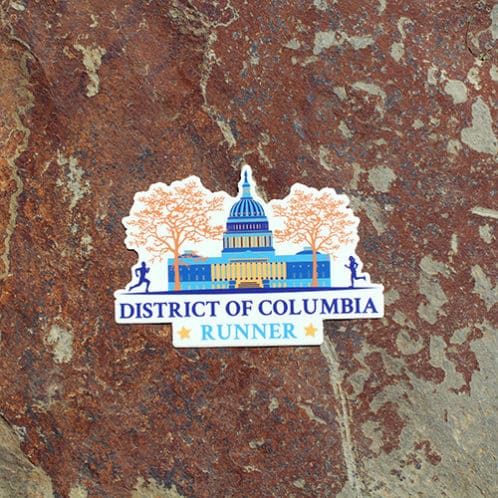 DC Runner sticker on rock background