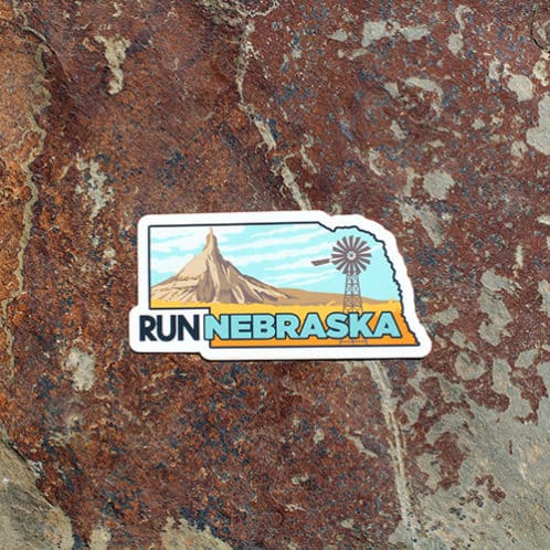 Nebraska Running sticker on rock background