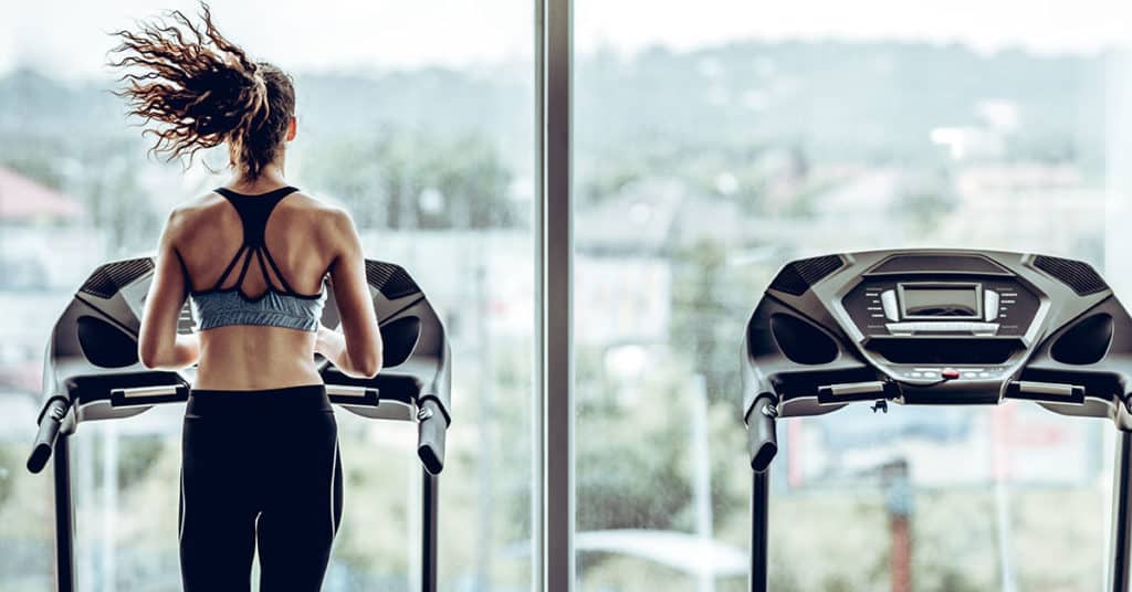 Woman in gym doing treadmill workouts