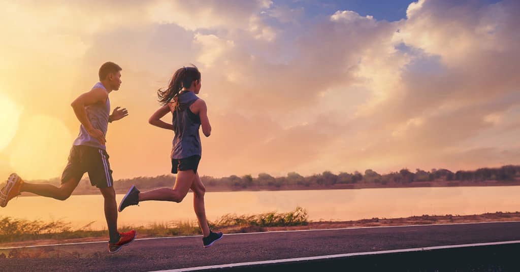 beginner runners on paved path running