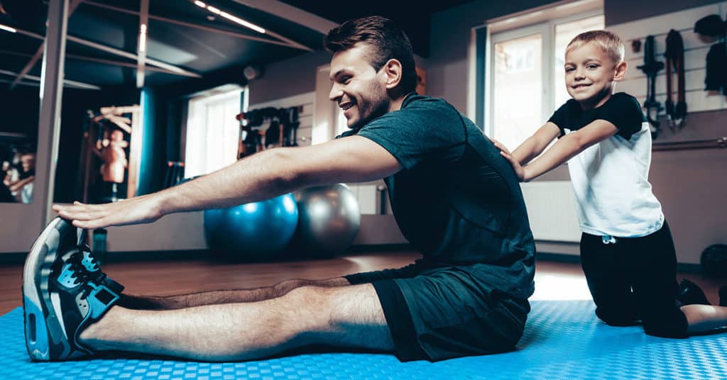 Father Finding Time To Train With Son in Gym