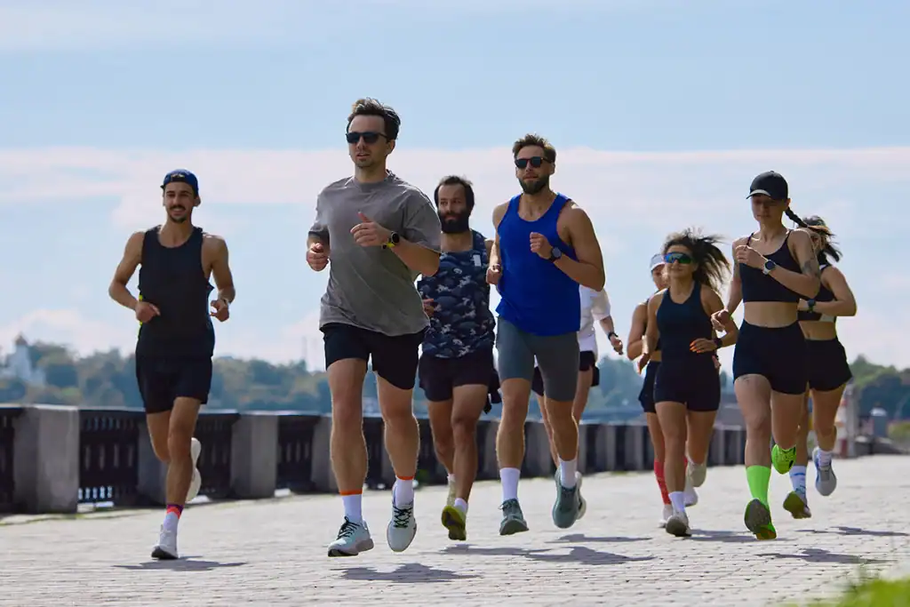 Group of runners training together outdoors for a beginner marathon training plan