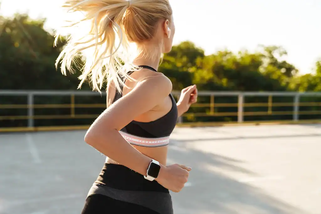 women running on road during intermediate half marathon training plan